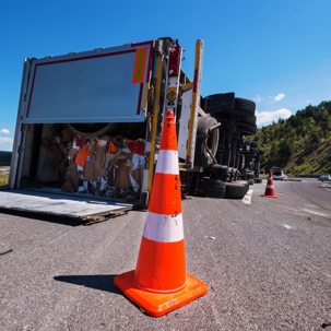 Semi on its side with open back doors after an accident
