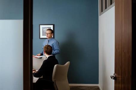 Two men in an office collaborate on professional development.