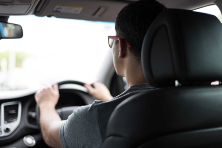 A picture of a guy, driving