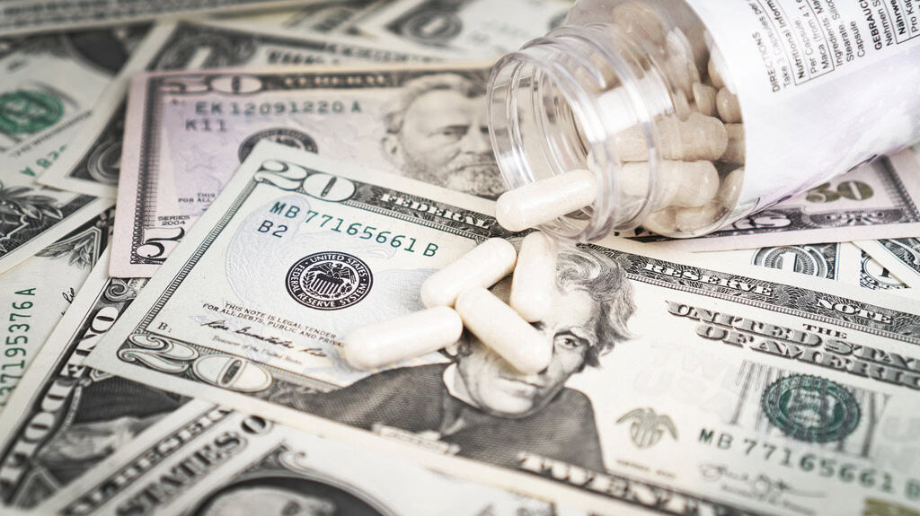pills spilling out onto paper money