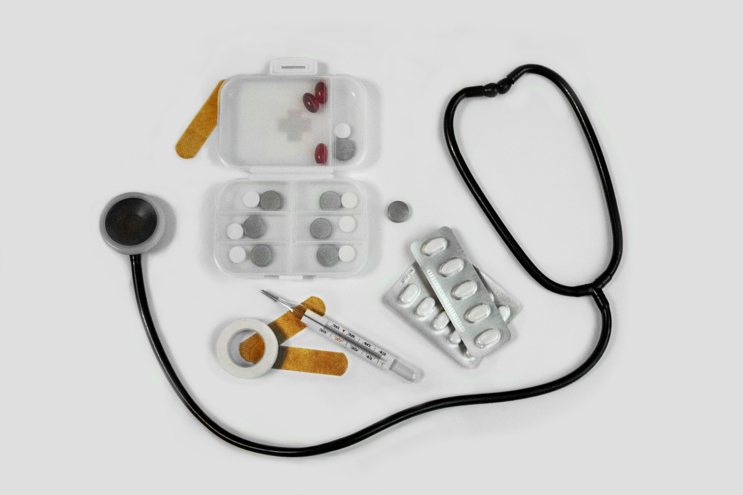 medication-and-a-stethoscope-on-a-white-table