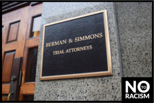Sign reading Berman & Simmons Trial Attorneys with graphic, "no to racism"