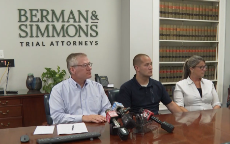 Attorney Michael Bigos and his client Deputy David Cole answer questions during a news conference. 