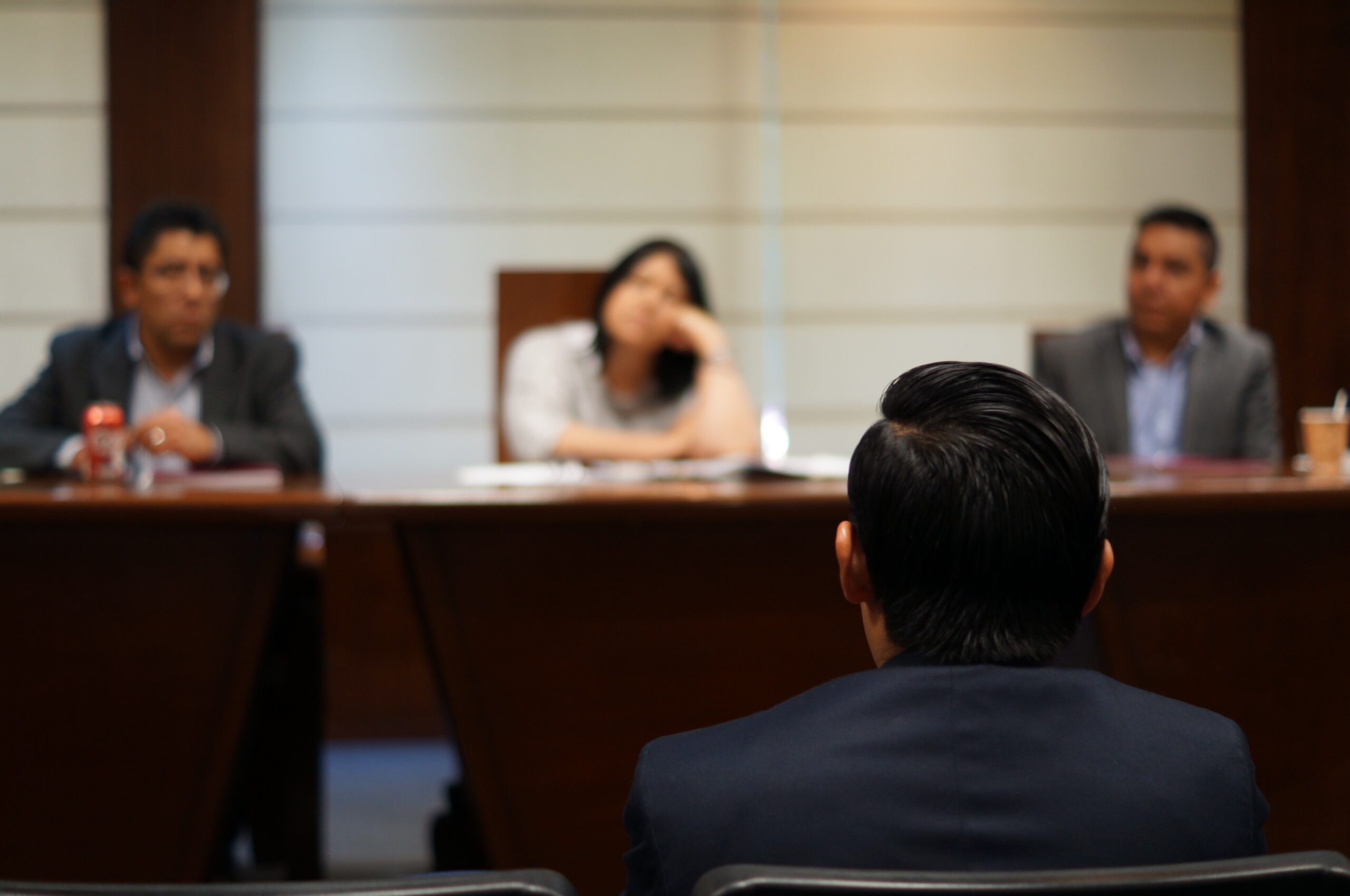 man-sitting-in-court-in-front-of-a-panel